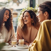 Group of friends smiling at coffee shop