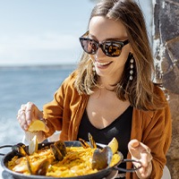 Smiling woman eating lunch outside