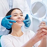 Dentist showing woman the results of her professional teeth whitening